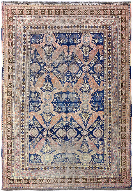 Full overhead view of 7'4" x 9'5" Caucasian Sumak rug with indigo field and rust diamonds