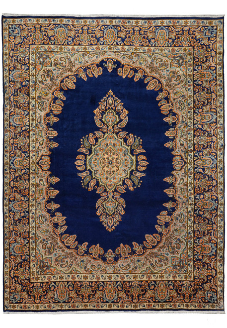 Navy blue open field Persian Kerman rug with salmon medallion and ivory floral borders, full view