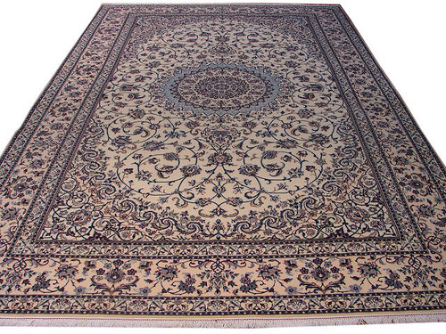6'8" x 10'1" Persian Nain rug displayed at an angle showing ivory field and navy border