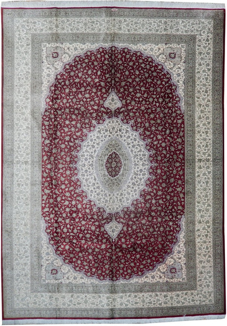 Full view of 8' x 11' Persian Qum silk rug with burgundy field and ivory oval medallion
