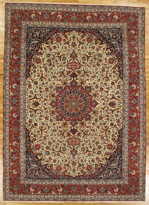 Ivory field Persian Isfahan rug with red floral border and central navy medallion, overhead view