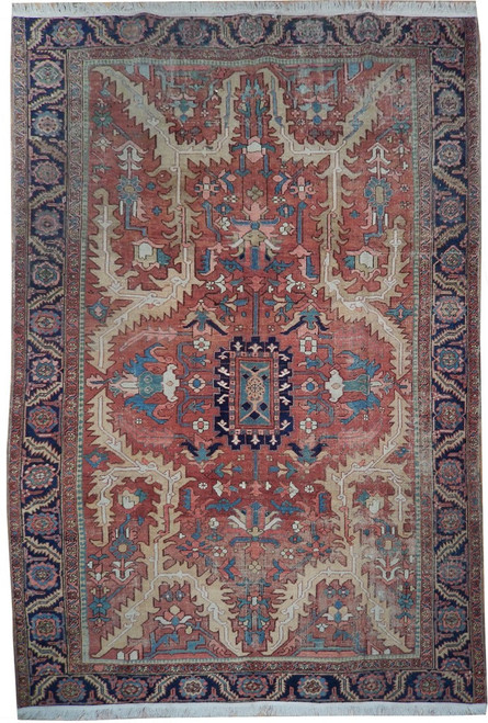 Rust red Persian Serapi rug with navy border, camel spandrels and stepped geometric central medallion