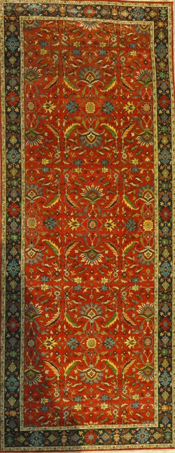Coral tomato field with all over floral vines framed by a navy blue border, full rug view