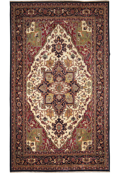 Full view of ivory and navy Serapi Heriz rug with stepped star medallion