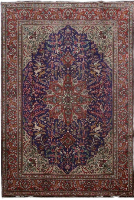 Full view of 8'2" x 12'1" Persian Tabriz rug with dark indigo field and red star medallion