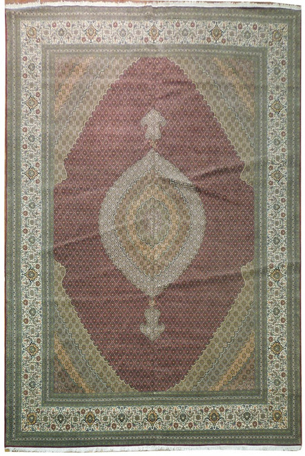 Full overhead view of pomegranate red Persian Tabriz rug with ivory scalloped medallion and border