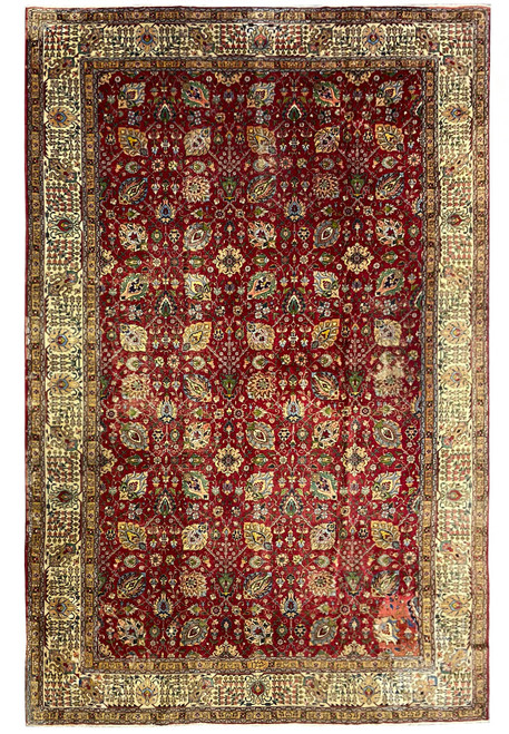 Oversize 12x18 Persian Tabriz rug photographed flat showing red all-over floral field and wide ivory border