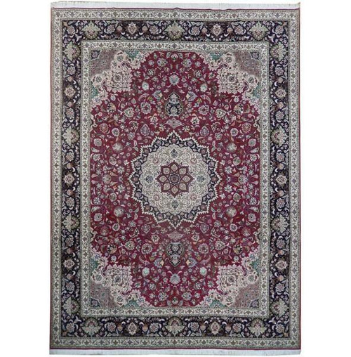 Red field Persian Tabriz rug with ivory star medallion and navy floral border, full overhead view