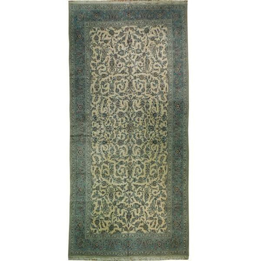 Oversize ivory and blue Persian Kashan rug photographed flat against a plain white studio background