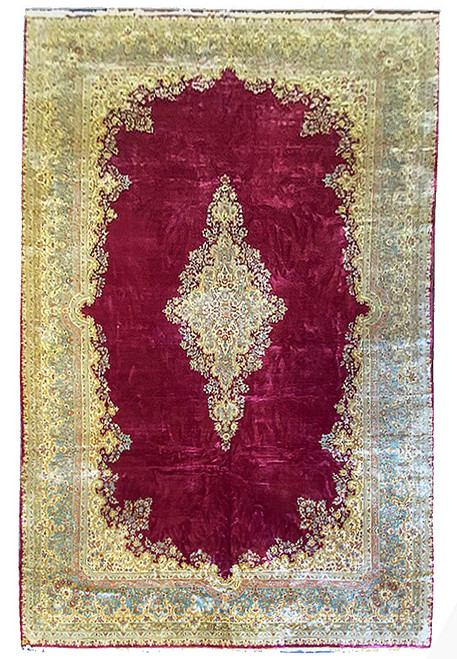 Burgundy open field Persian Kerman rug with ivory floral medallion and pale green floral border