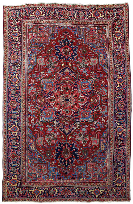 Full view of 6'5 x 9'10 Persian Heriz rug with red field and navy stepped medallion