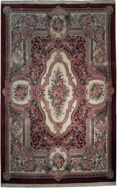 Full view of ivory and burgundy Savonnerie rug with pink rose medallion and acanthus scrollwork