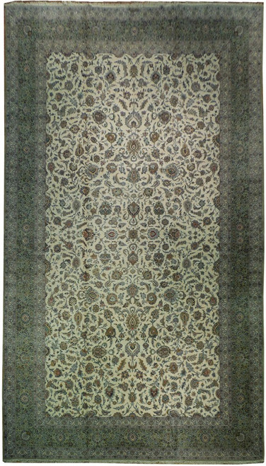 Overhead full view of ivory Persian Kashan palace rug with sage green floral border