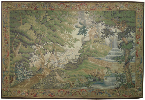 Full view of green Chinese verdure tapestry rug with woodland landscape, fountain and scrolling ribbon border