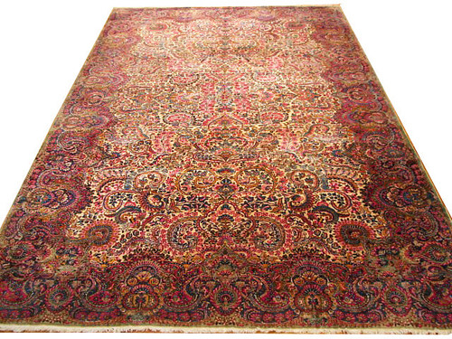 10'10" x 17'4" Persian Kerman rug shown flat with ivory field and deep rose floral border