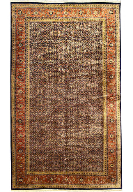 Full overhead view of navy Herati field oversize wool rug with rust floral border