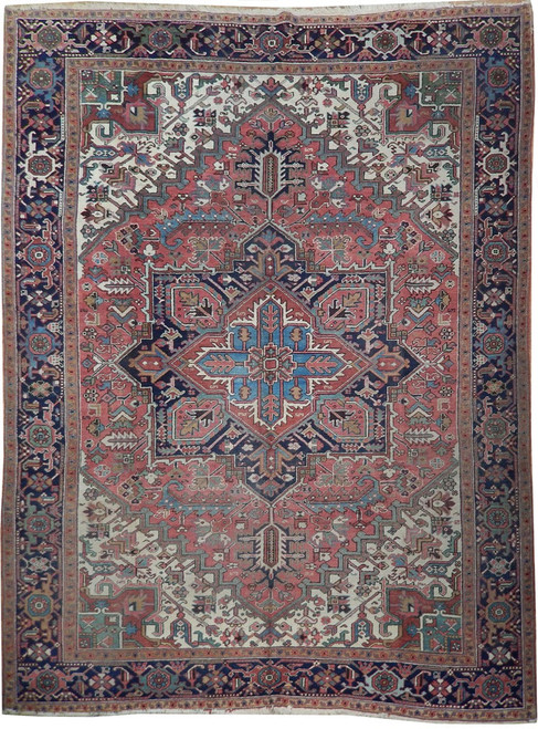 Antique 9x12 Persian Heriz rug with salmon field, navy border and ivory corner spandrels