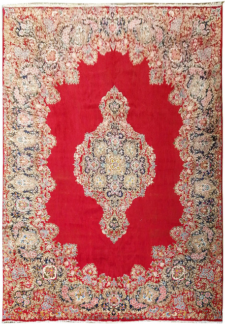 Full view of 11'6" x 16'5" Persian Kerman rug with red field and navy medallion