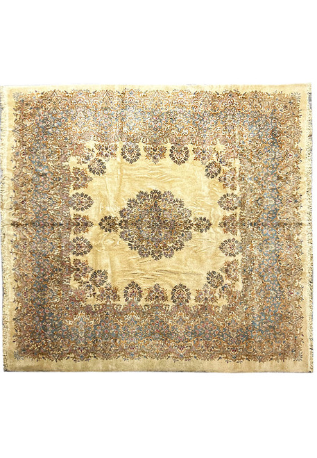 Full overhead view of ivory square Persian Kerman rug with blue floral medallion and wide border