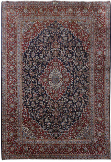 Full view of navy and red Persian Kashan rug with ivory floral medallion and matching corner spandrels