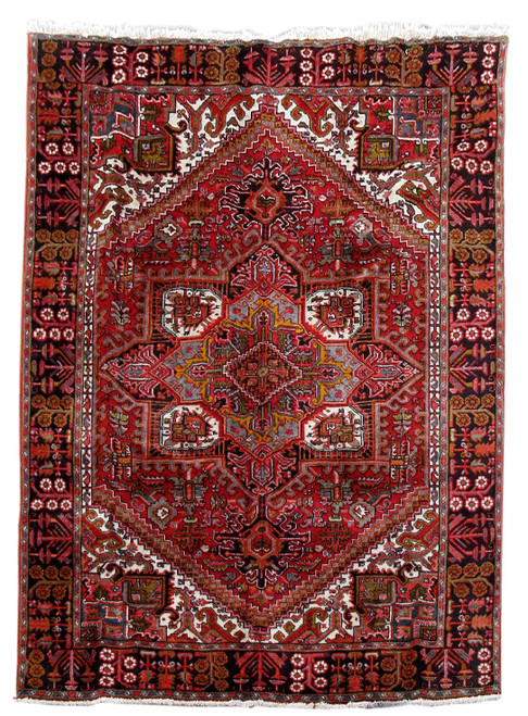 Full overhead view of 6'11" x 9'6" Persian Heriz rug with red field and navy border