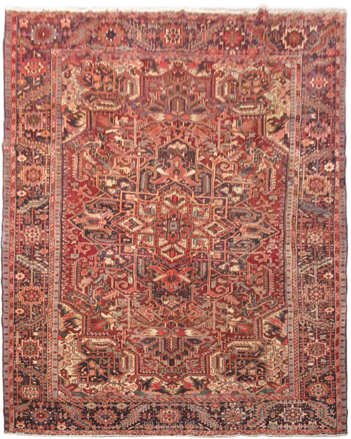 8 x 11 Persian Heriz rug with brick red field, geometric medallion and ivory corner spandrels