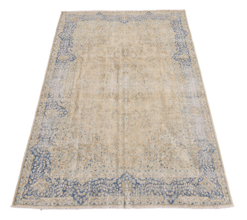 Full view of 7x11 khaki Oriental rug with denim blue floral border and ivory field