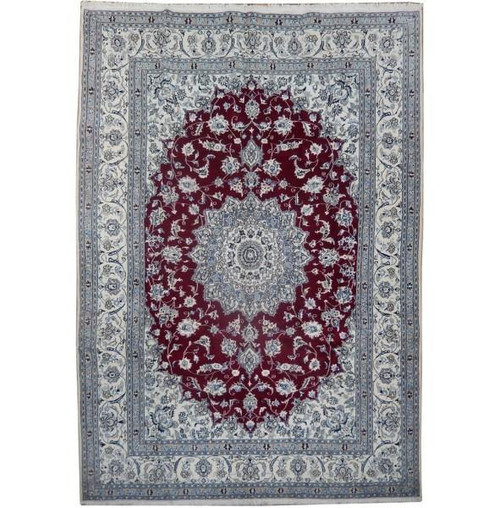 Ruby red and ivory Persian Nain rug with star medallion photographed flat on white background