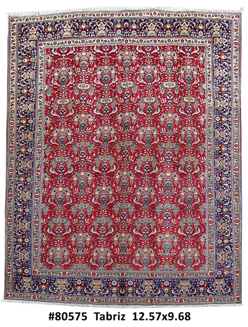Full view of red and navy Persian Tabriz rug with all over vase and bird design