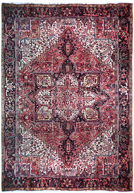 Full view of faded brick red Persian Heriz rug with navy stepped medallion and ivory spandrels