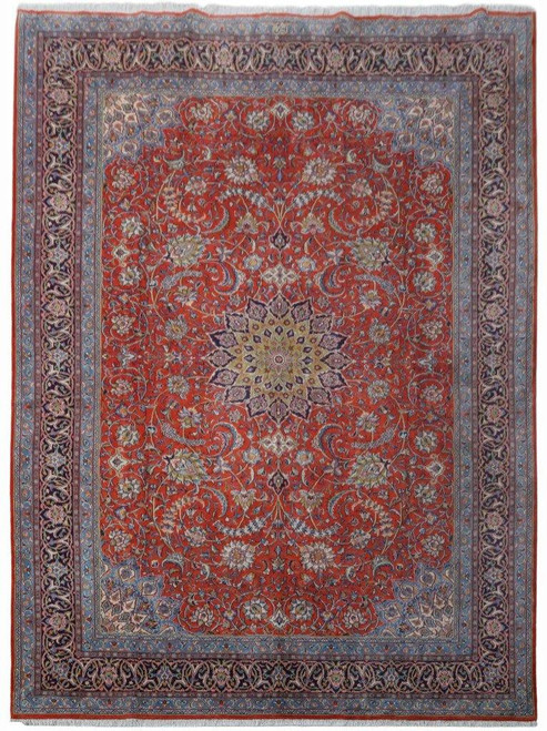 9'10" x 13'5" Persian Sarouk rug photographed flat showing red orange field and navy floral border