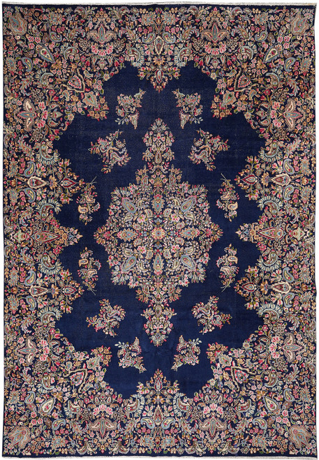 Full view of 9'8 x 13'5 Persian Kerman rug, navy field with pink and ivory floral medallion