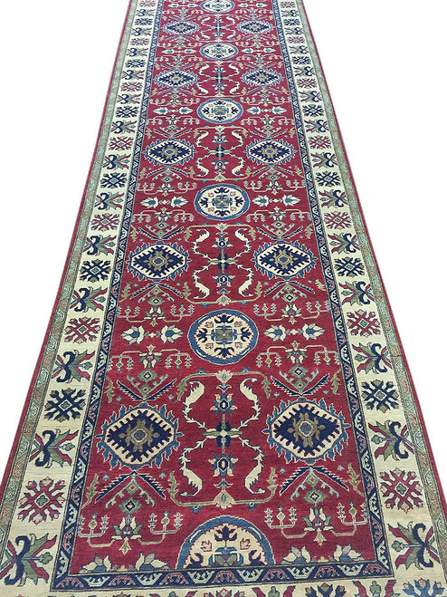 5'3" x 24' Kazak runner rug shown full length with red field and ivory border