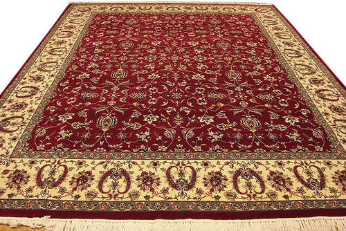Full view of 9' x 12'2" red Kashan design wool rug with ivory floral border