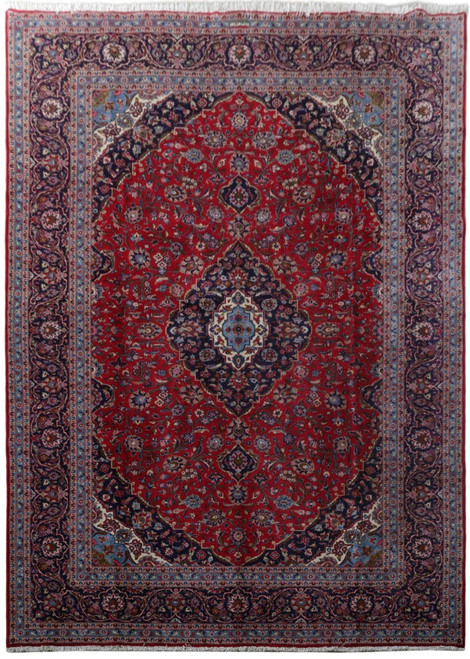 Full view of 9'9" x 13'7" Persian Kashan rug with red field and navy medallion