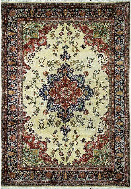 Overhead view of ivory field Persian medallion rug with navy border and rust floral corners
