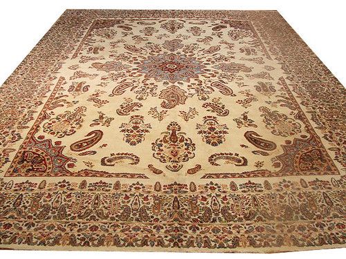 Cream Persian Kerman rug with light blue star medallion and all-over paisley field, shown fully