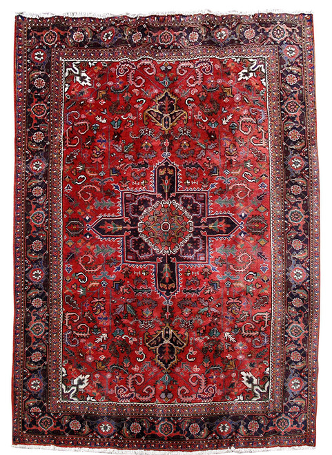 Full overhead view of 7'7" x 11'3" Persian Heriz rug with deep red field and navy medallion