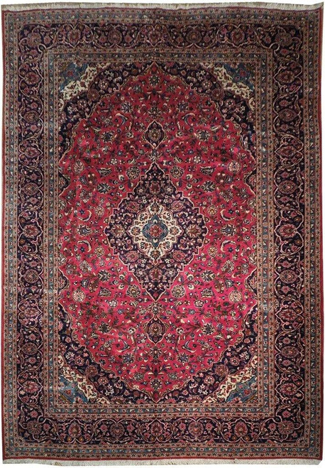 Ruby red Persian Kashan rug with navy floral border, ivory spandrels and central lobed medallion
