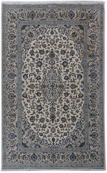 6'5" x 10'4" ivory Persian Ardakan rug shown flat with blue medallion and dense floral field