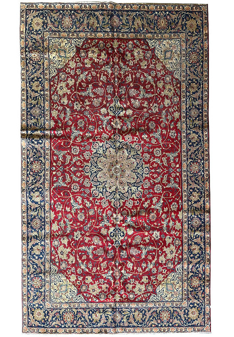 Full view of 9'7" x 16' Persian Isfahan rug with red field and navy floral borders