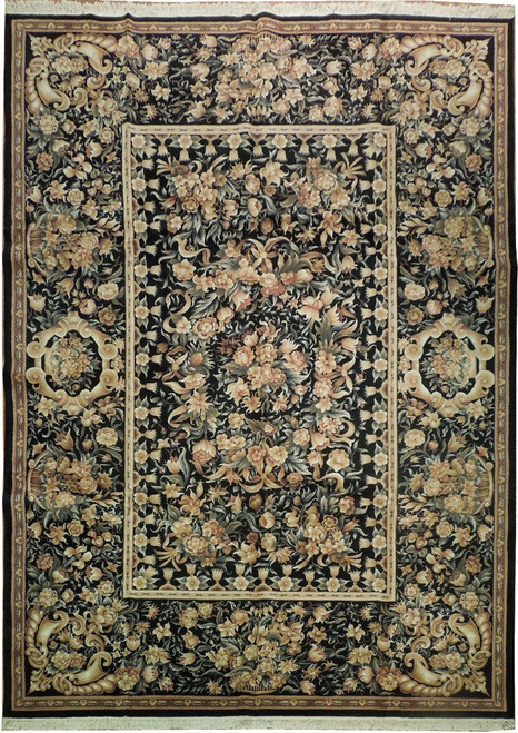 Full overhead view of black Aubusson rug with ivory inner panel border and peach floral sprays