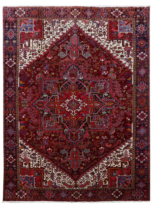 Dark brick red Persian Heriz rug with stepped geometric medallion and ivory corner spandrels, overhead view