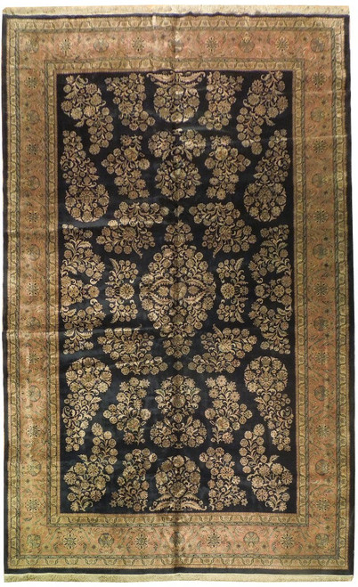 Full view of midnight blue Sarouk design rug with salmon floral border and ivory fringe