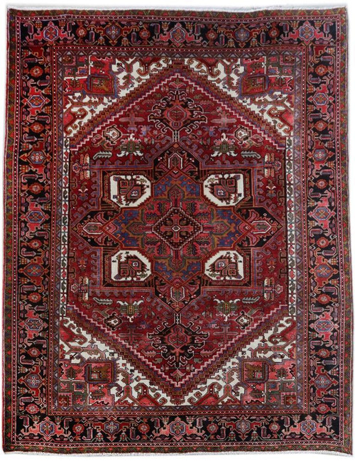 Ruby red Persian Heriz rug with black border, ivory corner spandrels and stepped geometric medallion