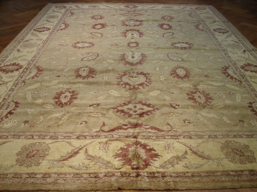 Full view of 9'9 x 13'9 Chobi Peshawar rug with sage green field and burgundy palmettes