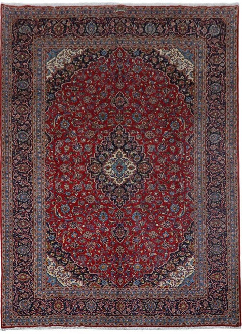 Red Persian Kashan rug with navy lobed medallion and ivory spandrels shown in full overhead view