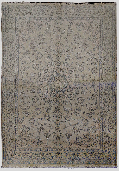 Full flat view of cream Persian Tabriz rug with all-over floral field and light blue border