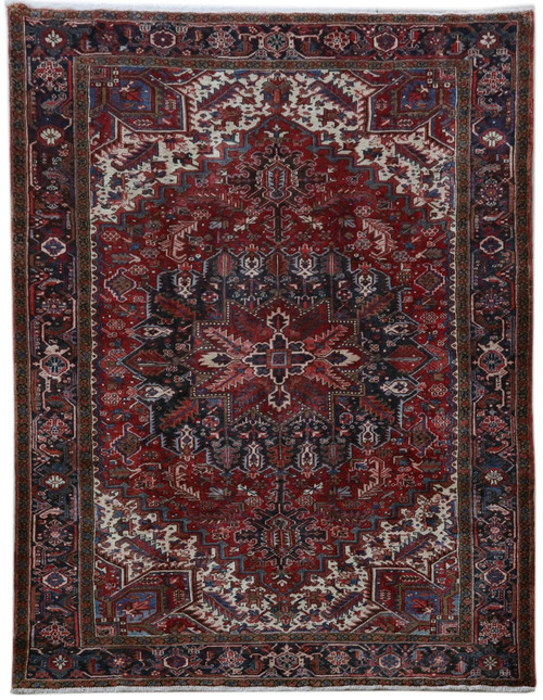 Full overhead view of 8'2" x 10'10" Persian Heriz rug with rust red field and navy border