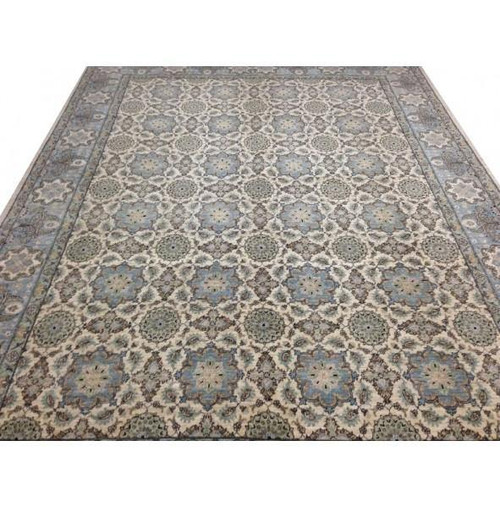 Ivory and blue Chobi Peshawar rug laid flat showing all over rosette lattice and blue border